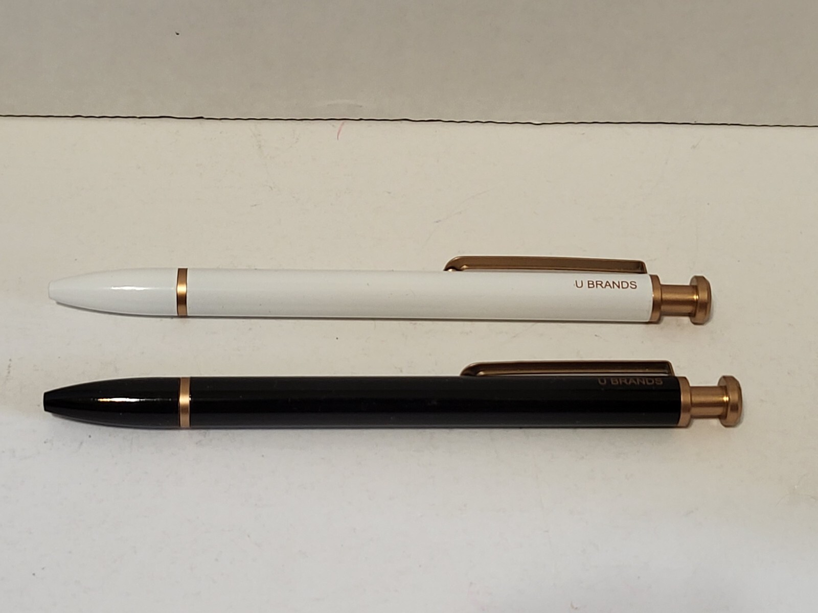 U Brands pens- 2 count, 1 black, 1 white, gold color trim