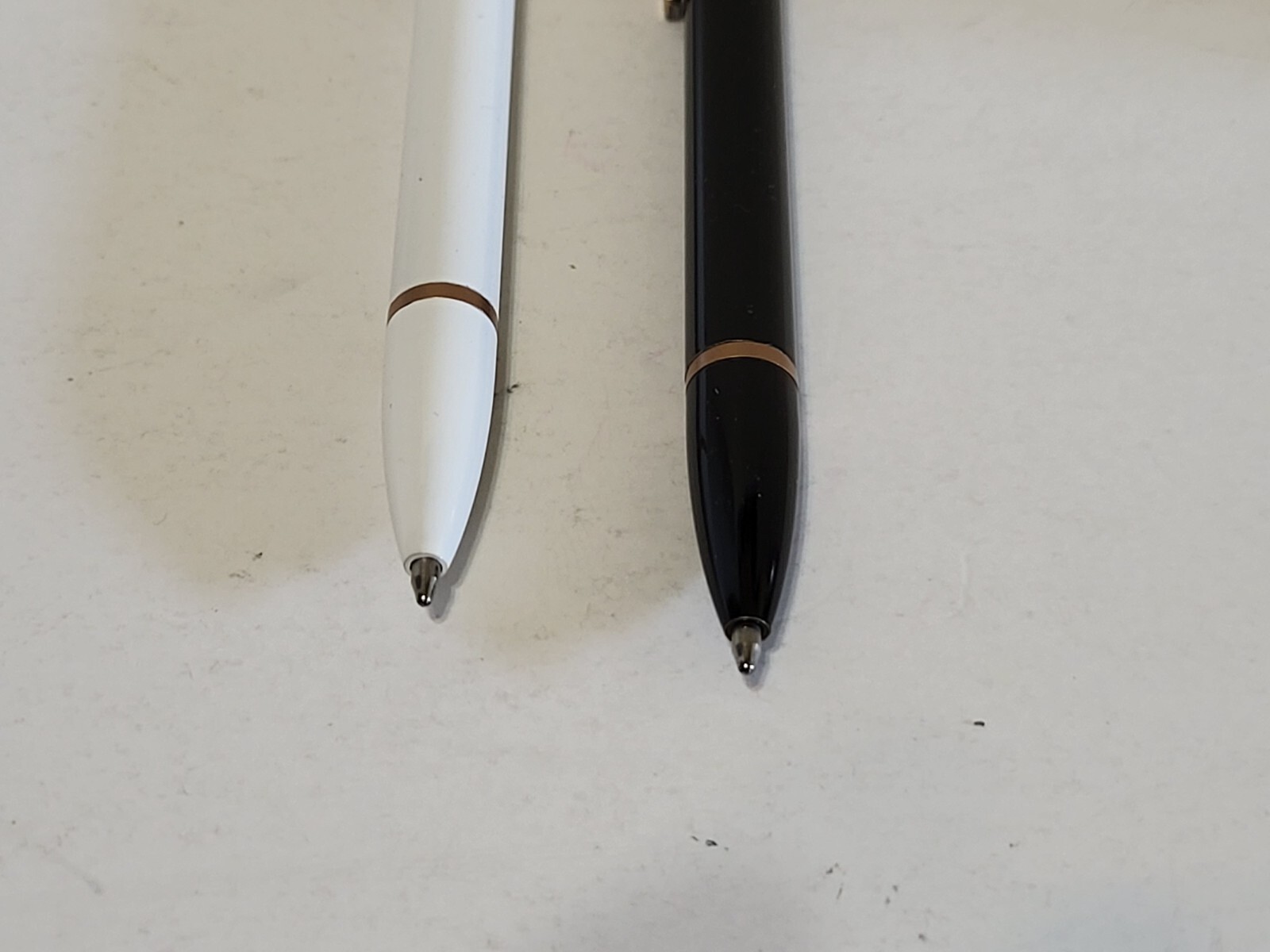 U Brands pens- 2 count, 1 black, 1 white, gold color trim